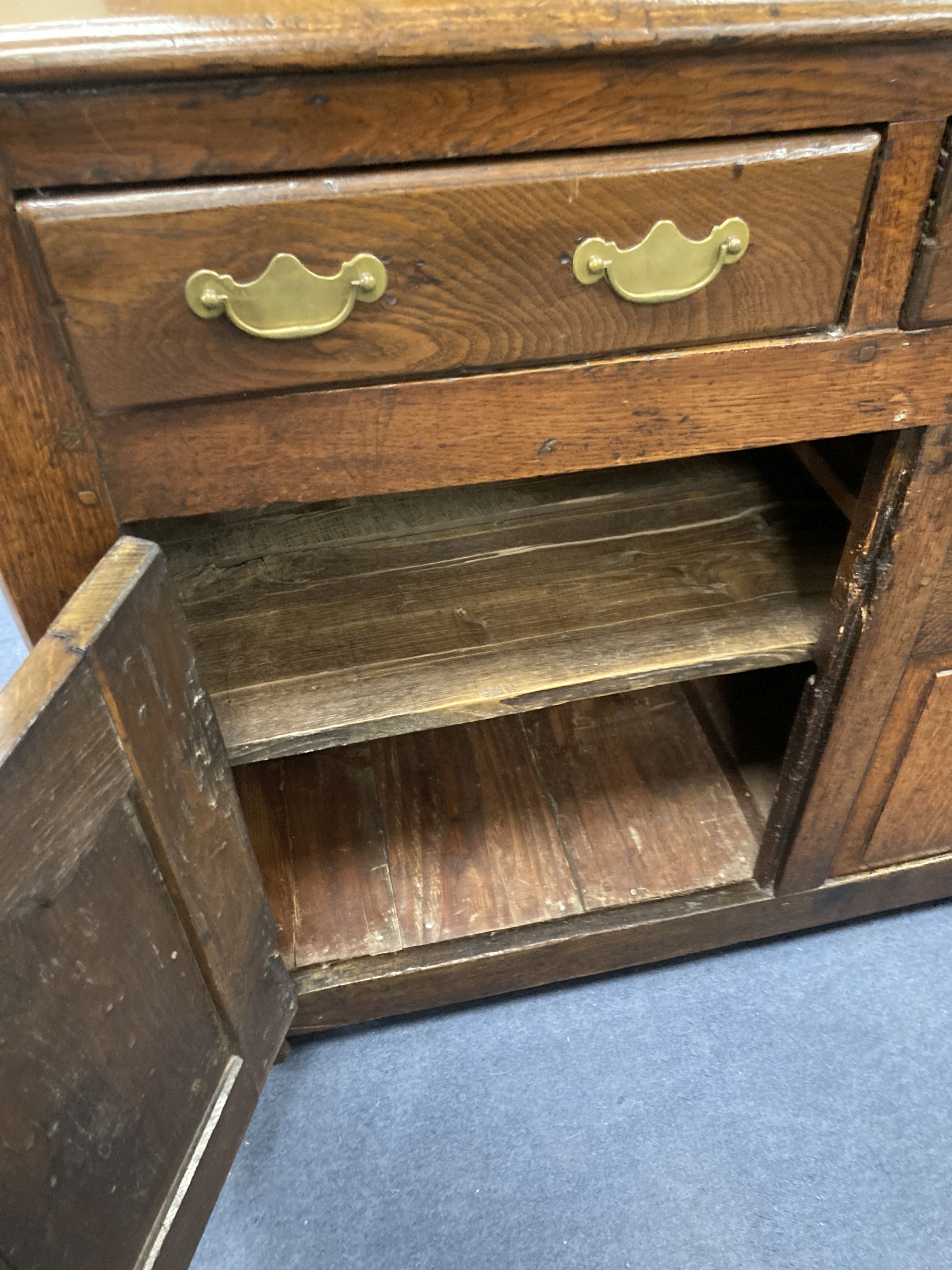 A mid 18th century oak dresser base, length 140cm, depth 46cm, height 86cm